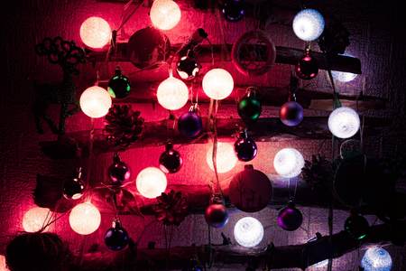 Christmas tree made from sticks and twigs background and Christmas decorations sparkling, glowing in different colors. Happy New Year and Merry Christmas.の写真素材