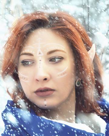 Elf Fairy woman. Close up portrait of an elf girl. Cold snowstorm in winter.の写真素材