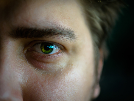 Green eye. Macro. Red bags under the eyes.の写真素材