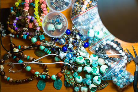 Buds of polymer clay, round pliers, working space.   Beautiful original beads from polymeric hand-worked clay.の写真素材