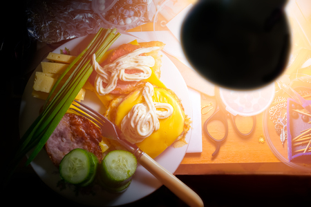 Quick snack at the workplace in the evening.  Working table with a plate with two sandwiches and sliced cucumbers.の写真素材