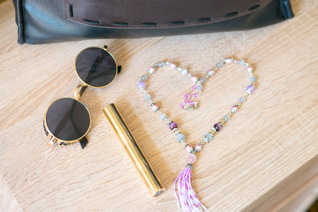 Glasses, mascara, decoration, bag. Girl is going to the event.の写真素材