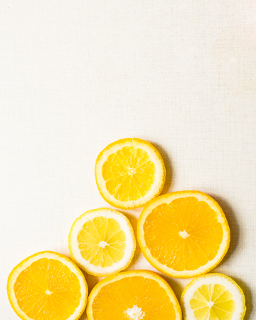 Juicy slices of an orange on a white, fruity background, top view. Vertical.の写真素材