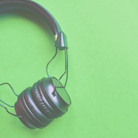 Wireless headphones on colorful green background for music sound Isolated. 1x1 cropの写真素材