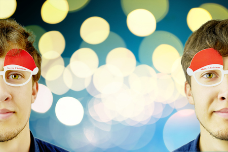 Portrait of a mans in funny Christmas glasses. Two guy in christmas concept backround.の写真素材