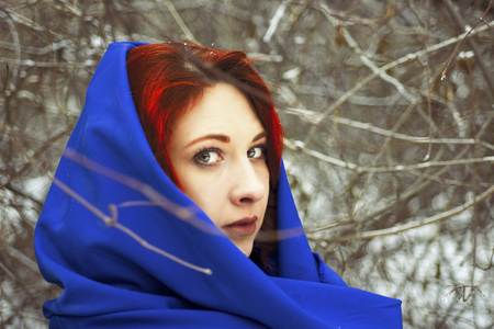 Portrait of a woman in a cold winter. Happy young woman in winter for a walk in nature.の写真素材
