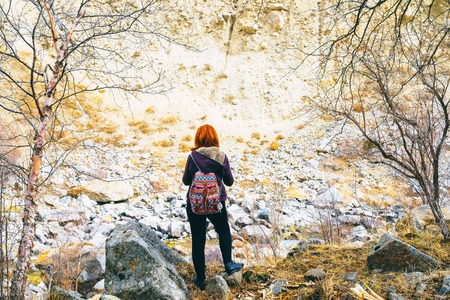 Hiker woman with backpack. Hiker female with backpack and sleeping bag walking in the mountains.の写真素材