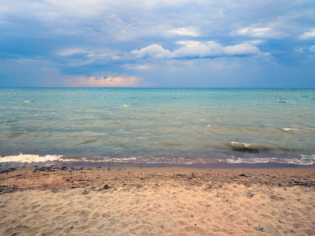 Beach and bad weather. The coast of the sea with small waves. Spoiled vacationの写真素材