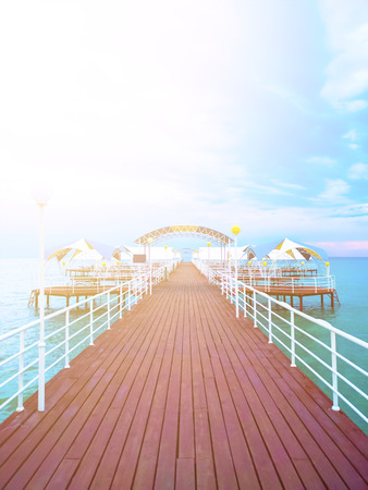 Summer day on the pier in the ocean. Wooden pier with blue sea and blue sky backgroundの写真素材