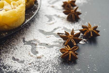 Scattered with powder and cinnamon on a black table top viewの写真素材