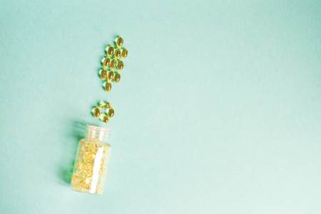 Yellow lollipops in a jar scattered in the shape of a exclamation mark on a green backgroundの写真素材