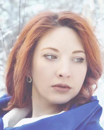 Portrait of a woman in a cold winter. Beautiful young woman in wintertime outdoor. Winter concept.の写真素材
