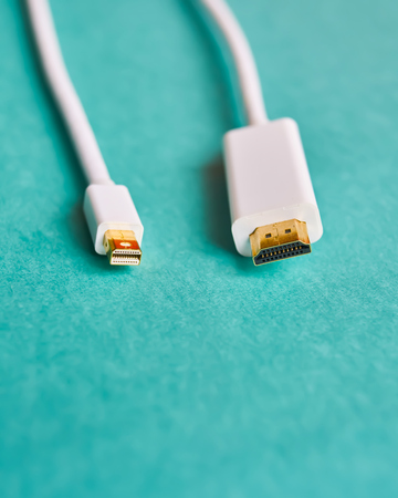 Closeup of HDMI and mini display port cables on blue backgroundの写真素材