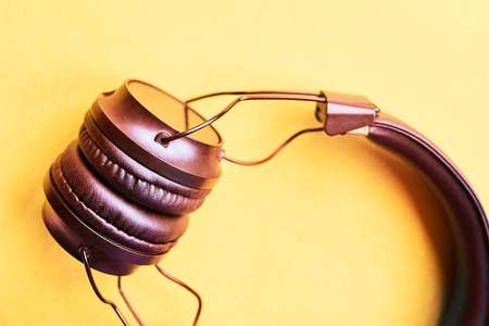 Wireless headphones on pastel backgrounds, top view. Trendy minimal style with colorful paper backdrop.の写真素材