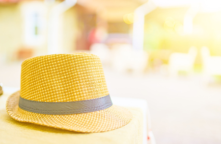 Straw hat on a hot day off on the table in the cafeの写真素材