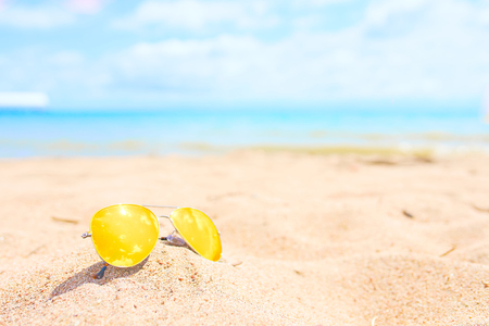 Yellow sunglasses on the beach. Resort conceptの写真素材
