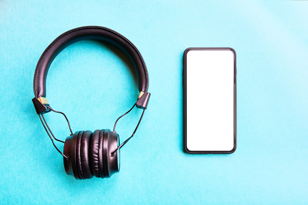 Wireless Headphones and bezel-less smartphone on colorful background. Minimal style with colorful paper backdrop.の写真素材