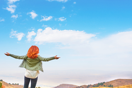 Beauty woman outdoors enjoying nature, raising hands. Beautiful Teenage Model girl with long healthy blowing hair running on the Spring Field, Sun Light Glow Sun. Free Happy Woman.の写真素材