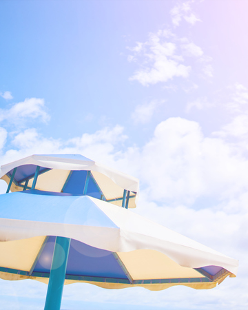 Beach umbrella on sunny day. Colorful of umbrella on the beach photo in outdoor sunlight lighting.の写真素材
