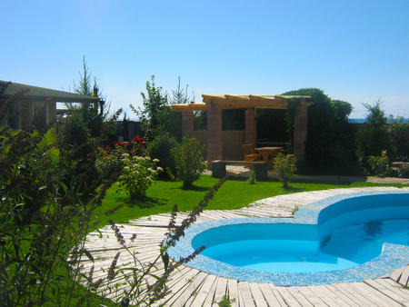 Small pool in the backyard with garden summer houseの写真素材