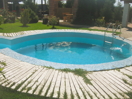 Small pool in the backyard with garden summer houseの写真素材