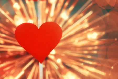 Concept of Valentines day. cut out red paper in the form of a heart on the background of bright bulbsの写真素材