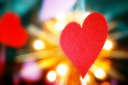 Concept of Valentines day. cut out red paper in the form of a heart on the background of bright...