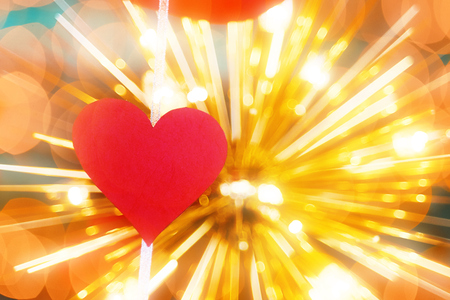 Concept of Valentines day. cut out red paper in the form of a heart on the background of bright bulbsの写真素材