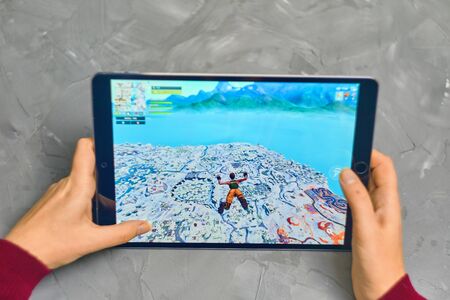 Bishkek, Kyrgyzstan - January 21, 2019: Woman playing fortnite game of epic games company on Apple...