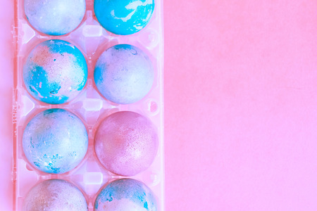 Painted Easter eggs with space intergalactic pattern in stand on magenta backgroundの写真素材