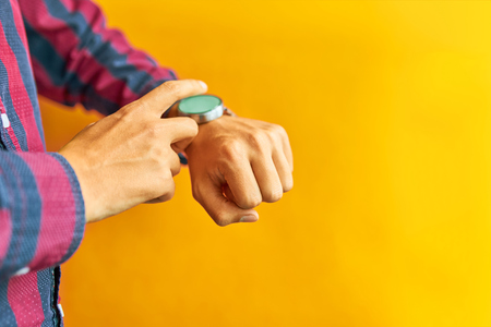 Smartwatch - modern digital gadget with empty display, copy space. Yellow backgroundの写真素材