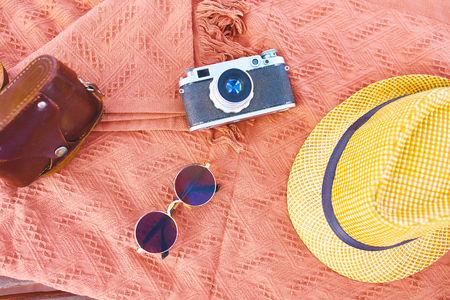 Beach hat, camera, sunglasses on the beach on a Sunny day. Vacation conceptの写真素材