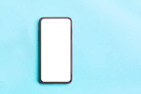 Smartphone on colorful background. Flat lay concept: telephone on pastel blue backgrounds.の写真素材