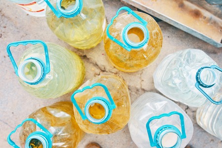 Bottles of water. Plastic water bottles. 5 litre plastic water bottles reused in vegetable garden.の写真素材
