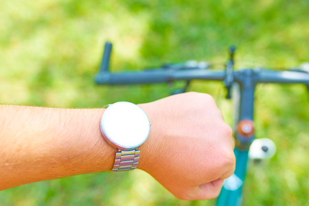 Man conducts Cycling training with a smart watch on the offroad at spring. Mock upの写真素材