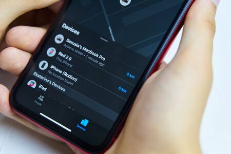 Bishkek, Kyrgyzstan - July 6, 2019: The Find my application shows all connected devices of the owner. New application on iPhone. Close up.のeditorial素材