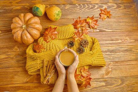 Autumn Flat Lay. Pumpkin,coffee, fall leaves. Nuts,acorns on rustic blanket and wood background top view. Seasons greetings.の写真素材