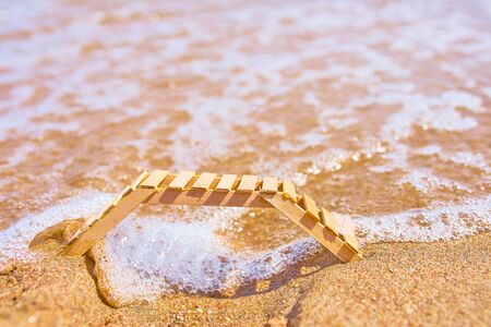 Wooden deckchair on a tropical sand beach. Wooden sunbed on tropical beach in the Maldives at summer day.の写真素材
