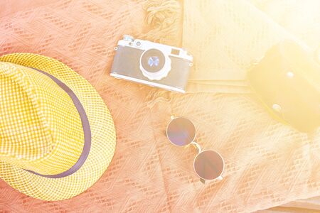 Beach hat, camera, sunglasses on the beach on a Sunny day. Vacation conceptの写真素材