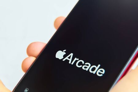 Bishkek, Kyrgyzstan - June 05, 2019: New Apple Arcade logotype on modern iphone featuring new subscription model for over 100 groundbreaking new gamesのeditorial素材
