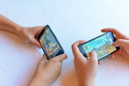Bishkek, Kyrgyzstan - January 17, 2019: Two friends play pubg coop multiplayer battle royale game on iPhone and Android. Gameplay actionのeditorial素材