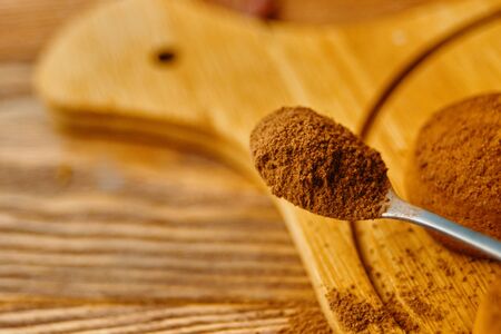 A pile of cookies and a spoonful of cocoa.の写真素材