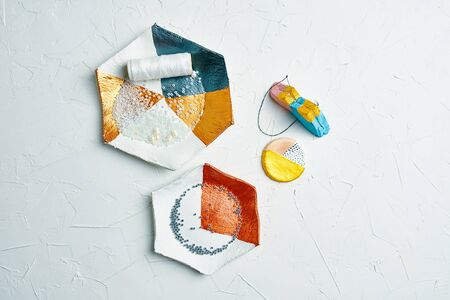 Process of creating jewelry with elements of beads, river pearls and threads on the tableの写真素材