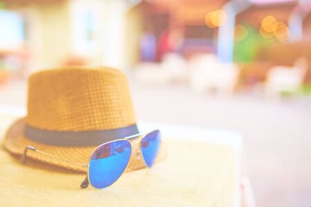 Straw hat on a hot day off with blue sunglassesの写真素材