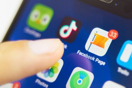 Bishkek, Kyrgyzstan - July 6 2019: Facebook Page application icon on Apple iPhone X smartphone screen close-up. Social Networkのeditorial素材