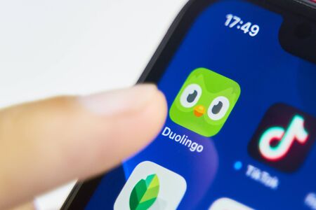 Bishkek, Kyrgyzstan - July 6 2019: Icon of the Duolingo program on the iPhone screen.のeditorial素材