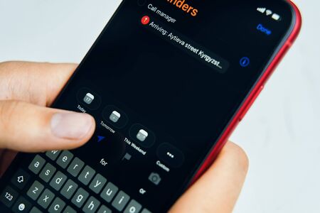 Bishkek, Kyrgyzstan - July 6 2019: New reminders application in ios 13. The person writes a reminder on the phone in a new application on iPhone X.のeditorial素材