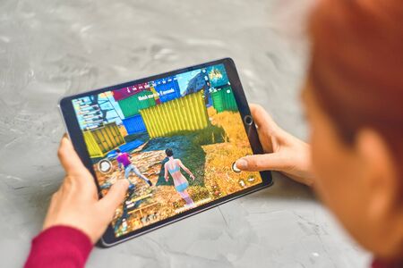 Bishkek, Kyrgyzstan - January 21, 2019: Woman playing pubg coop multiplayer battle royale game on Apple ios tablet iPad Proのeditorial素材