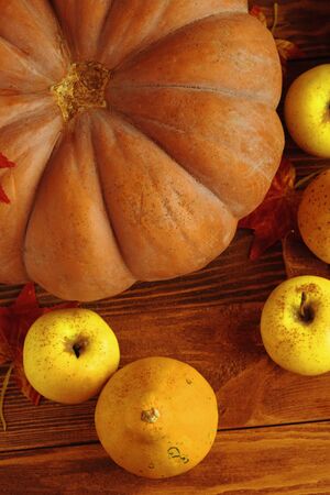 A bunch of pumpkins. Orange pumpkins on wood flat lay free space. Fresh squashes on wooden table, country autumn background. Seasonal, harvest, fall, organic food, dieting, healthy food conceptの写真素材
