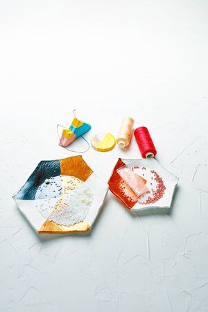 Process of creating jewelry with elements of beads, river pearls and threads on the tableの写真素材